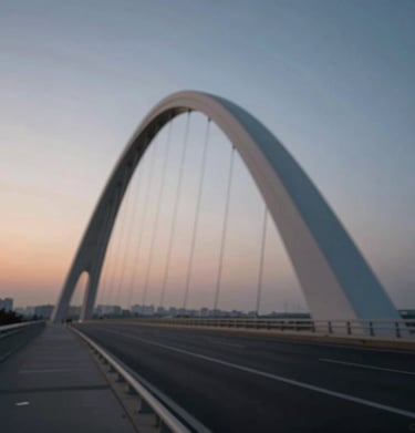 A long exposure photograph of a modern bridge structure, showing elegant curves and structural rhythm against a twilight sky.