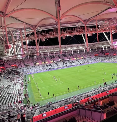 Aerial view of Chase Stadium in Fort Lauderdale during an Inter Miami soccer match at night.