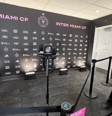 Inter Miami CF press conference room with microphones and branded backdrop at Chase Stadium.