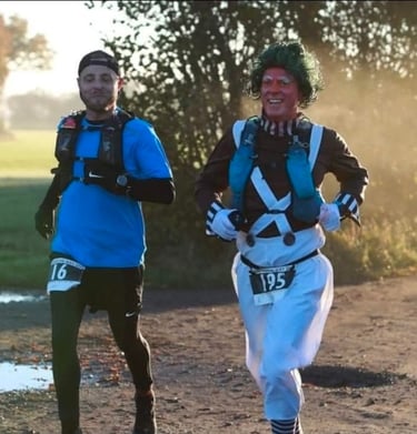 James Oswald Two Ultra marathon runners racing outdoors, including one man as an Oompa Loompa