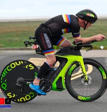 James Oswald Coaching in a triathlon competition riding a Cervélo PX5 with a Parcours rear wheel.