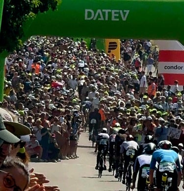 James Oswald Coaching Solar Hill crowded cheering section at a DATEV Challenge Roth triathlon event.