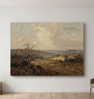 A medium shot of an original landscape painting with soft tan and muted brown hues, displayed in a bright, modern room.