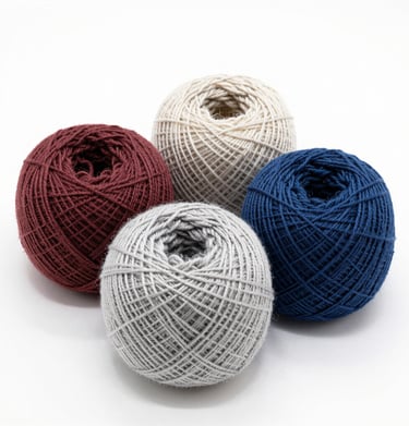 Artisan hands gently holding a skein of warm & glow yarn, showcasing its smooth texture.
