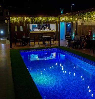 Inviting swimming pool area surrounded by lush greenery.