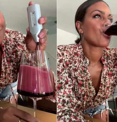 a woman drinking a glass of wine in a wine glass