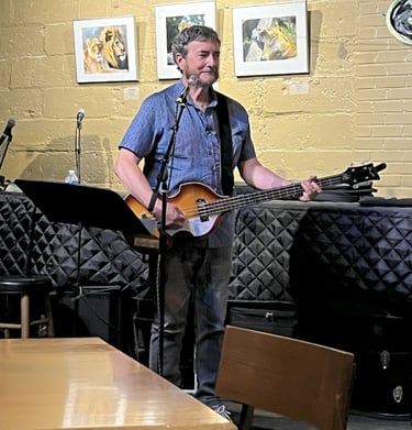 Dave of Crossmolina Band playing his Hofner bass at the Little Theater Cafe.