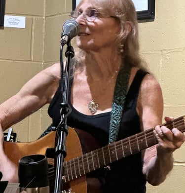 Annie of Crossmolina Band playing her 12 string Gild guitar..