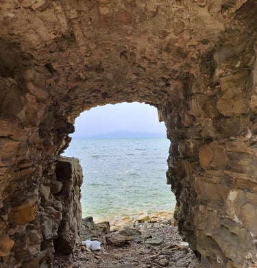 a stone archway leading to the ocean