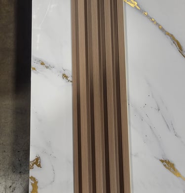 Wood slat wall panel sample placed over a white marble tile with gold veining for interior design.