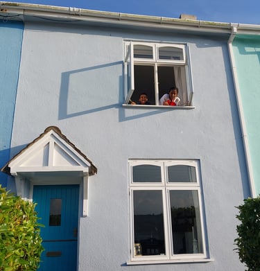 Familys enjoying kids looking out the colourful Devon houses