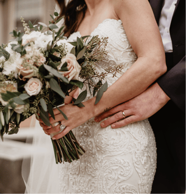 a cis couple on their wedding day, featuring the colour schemr through the brides bouquet of flowers