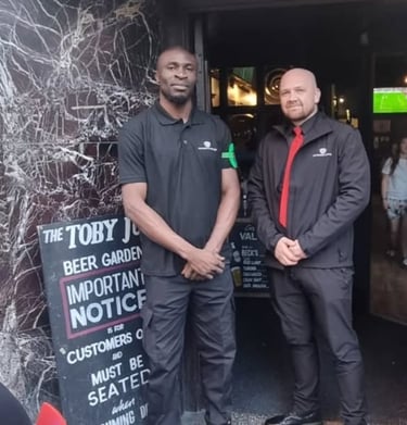 two security professionals standing in front of a venue
