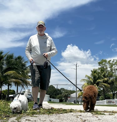 robert walking customers dogs in port saint lucie wearing a back's yard poop scooping shirt