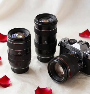 A flat lay of high-end photography lenses and a classic film camera on an off-white silk surface, surrounded by rose petals, reflecting a luxury brand image.