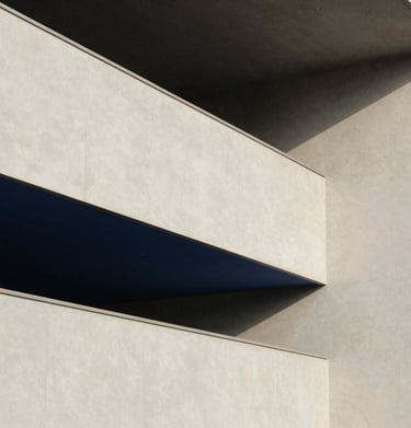 A minimalist architectural detail of a North American / US modern art museum, with soft light falling on off-white surfaces and sharp navy geometric shadows.