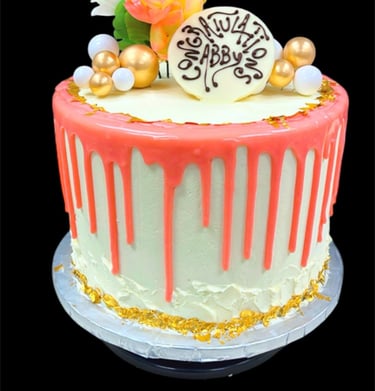 Custom graduation cake with pink drip frosting, gold leaf accents, and floral topper for Abby.