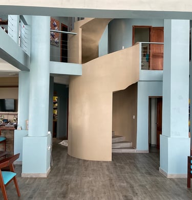 a living room with a spiral staircase and a spiral staircase