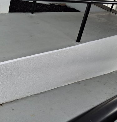 Freshly painted handicap access ramp into a dealership.