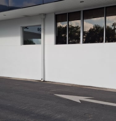 Fresh white paint on dealership's service drive.