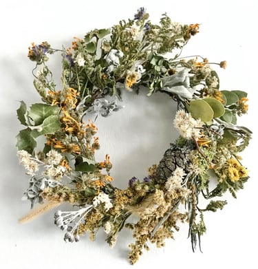 a wreath of dried flowers and foliage