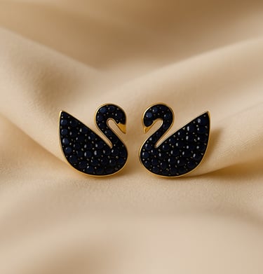 a pair of black swan - shaped earrings with black crystals