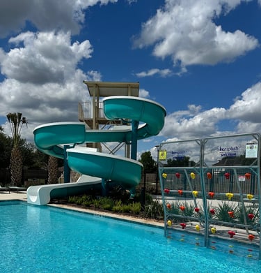 a water slider with a slider in the middle of a pool