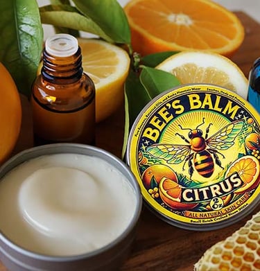 Bee's Balm Citrus Scent surrounded by beeswax and citrus fruit and essential oils