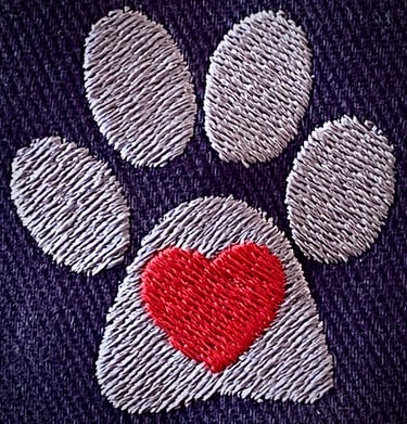 Tender Paws logo embroidery on blue background