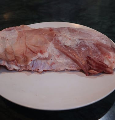 a piece of seena on a plate with a piece of meat on it