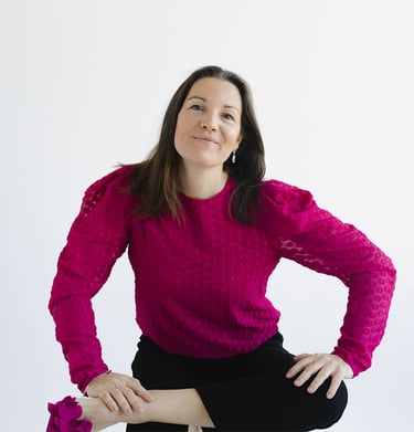 Megan Swan seated on chair smiling