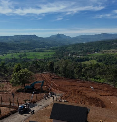 a construction site with a large amount of dirt and a tractor