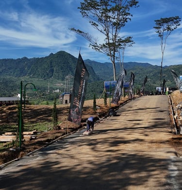 a dirt road with a mountain in the background