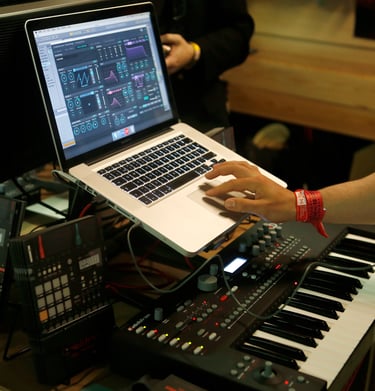 a person is using a laptop computer and a keyboard
