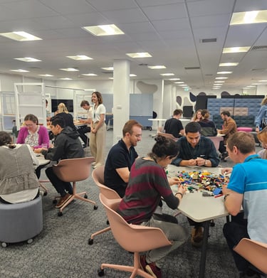 Workshop session with participants collaborating using Lego for team building activities