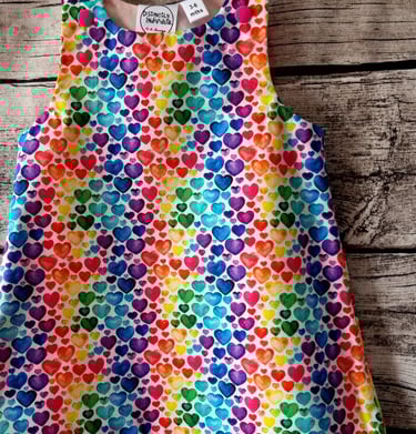 a colourful rainbow heart print dress for children