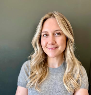 a woman with blonde hair and a gray shirt