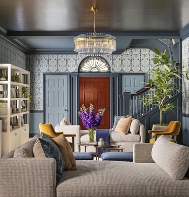 a living room with a couch and a clock
