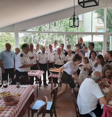 a group of people sitting at a table with food
