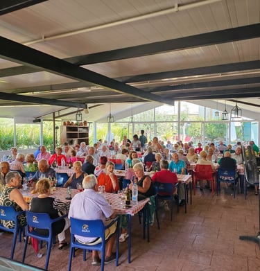 a large group of people sitting at tables in a restaurant
