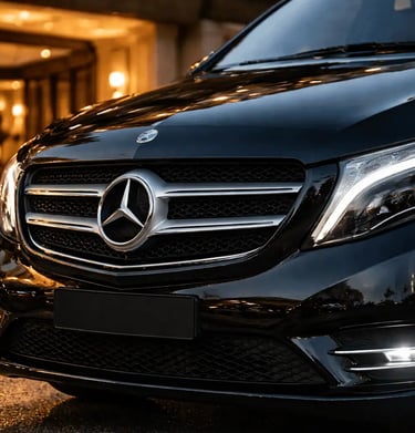 Front view of a premium black Mercedes-Benz Vito parked at a luxury hotel entrance in Athens