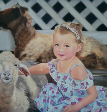 Little girl sitting with sheep at the zoo