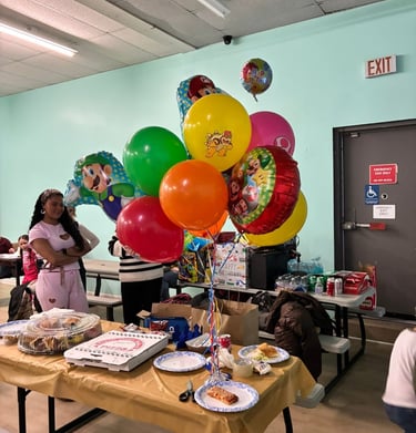 Birthday party setup with pizza and decorations at Yum Yum Fun family entertainment center