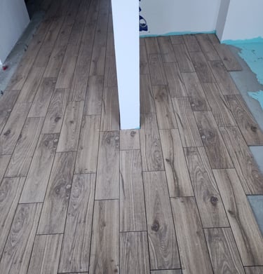 Elegant white interior featuring classic wall molding and a paneled door with vintage hardware.