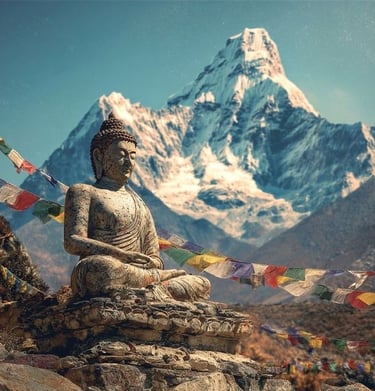 A stone Buddha statue with colorful prayer flags in front of a snow-capped Himalayan mountain.