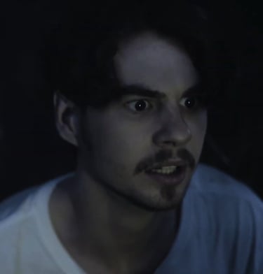 a man with a beard and a white shirt