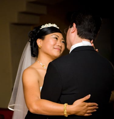 Bride and Groom. First dance contemplating and smiling at each other.
