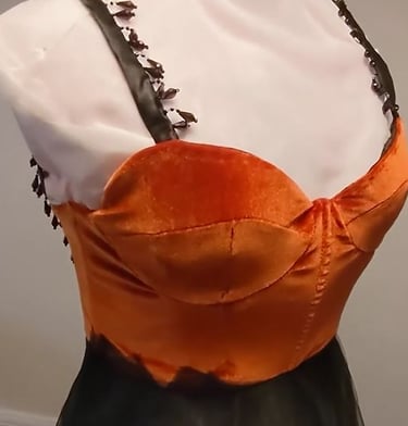 A burnt orange velvet sweetheart neckline dress with beaded black straps