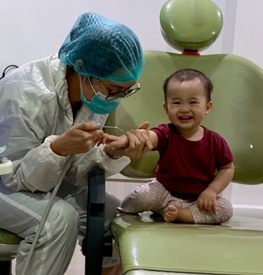 a woman in a surgical mask and a baby in a chair