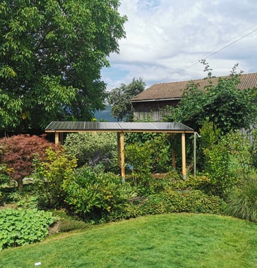 A wooden garden pergola with integrated solar panels installed in a lush backyard landscape.